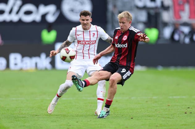 September 19, 2026, Bundesliga Soccer, Eintracht Frankfurt vs. SC Freiburg, from left, Lukas Kübler (SC Freiburg) and Jonathan Burkardt (Eintracht Frankfurt). DFL and DFB regulations prohibit any use of photographs as image sequences and or quasi-video. xdcx Copyright: HMBxMedia Claus
