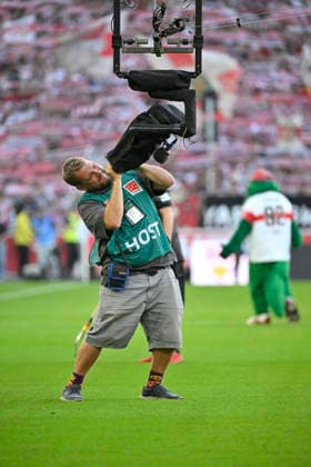 TV crew member cleans the lens of the Spidercam during the VfB Stuttgart vs. Borussia Dortmund (BVB) game on September 19, 2026. DFL regulations prohibit any use of photographs as image sequences and or quasi-video. VfB Stuttgart vs. Borussia Dortmund (BVB)