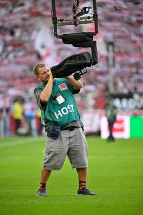 TV crew member cleans the lens of the Spidercam during the VfB Stuttgart vs. Borussia Dortmund (BVB) game on September 19, 2026. DFL regulations prohibit any use of photographs as image sequences and or quasi-video. VfB Stuttgart vs. Borussia Dortmund (BVB)