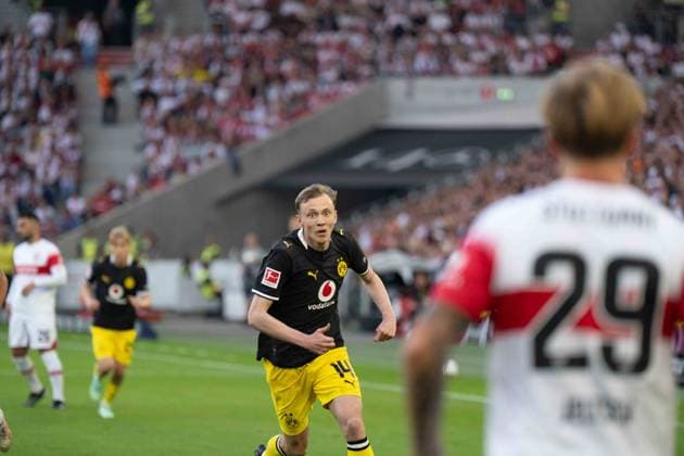 September 19, 2026: Soccer, VfB Stuttgart vs. Borussia Dortmund, Matchday 4 of the Bundesliga 1 at the MHP Arena. Maximilian Beier of Borussia Dortmund (No. 14) runs toward Finn Jeltsch of VfB Stuttgart (No. 29) with a determined look on his face, IMPORTANT NOTICE: In accordance with DFL and DFB regulations, it is prohibited to use or allow the use of photographs taken in the stadium and or during the game in the form of sequential images and or video-like photo sequences. Copyright: xJamesxZabelx