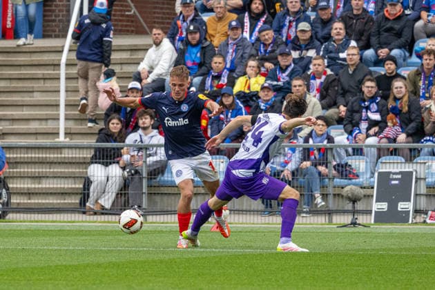 September 19, 2026 Soccer 2. Bundesliga Men s 2026–2027 Season, Matchday 6: Holstein Kiel vs. VFL Osnabrück; Kiel in blue and white, Osnabrück in white and purple; Gyan de Regt li, Jannik Müller, Holstein Kiel Stadium, Westring 501, Schleswig-Holstein, Germany