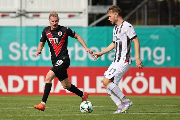 September 19, 2026, xsefx, Soccer, FC Viktoria Köln vs. FC Ingolstadt 04, 3. Liga, Sportpark Höhenberg, Matchday 7, 2026–2027 season: Meiko Sponsel of FC Viktoria Köln 19 in a tackle with Benjamin Kanuric of FC Ingolstadt 04. 37 DFB regulations prohibit any use of photographs as image sequences and or quasi-video. North Rhine-Westphalia, Germany