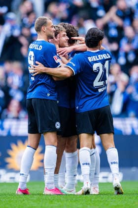 September 20, 2026 Soccer, 2026–2027, 2. Bundesliga, Matchday 6, DSC Arminia Bielefeld 1 FC Heidenheim. M Joel Grodowski of Bielefeld celebrates his 1–0 goal in a huddle with L David Min of Bielefeld, R Stefano Russo Bielefeld DFL REGULATIONS PROHIBIT ANY USE OF PHOTOGRAPHS AS IMAGE SEQUENCES AND OR QUASI-VIDEO