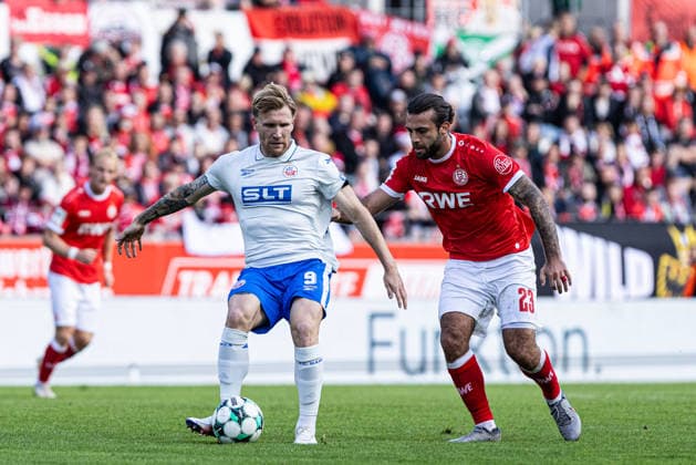 3rd Division, Matchday 7: Rot-Weiss Essen vs. Hansa Rostock, September 20, 2026; Andreas Voglsammer, Hansa Rostock, 9, Jose Enrique Rios Alonso, Rot-Weiss Essen, 23, 3rd Division, Matchday 7: Rot-Weiss Essen vs. Hansa Rostock at Stadion an der Hafenstraße, Essen, September 20, 2026. DFL regulations prohibit any use of photographs as image sequences and or quasi-video. Copyright: xBEAUTIFULxSPORTS Buriakovx