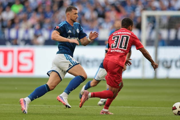 Edin Dzeko of FC Schalke 04 and Jan Gyamerah of SV 07 Elversberg during a 2026–27 Bundesliga 1 match between FC Schalke 04 and SV Elversberg. Copyright Thomas Pakusch Copyright: Thomas Pakusch
