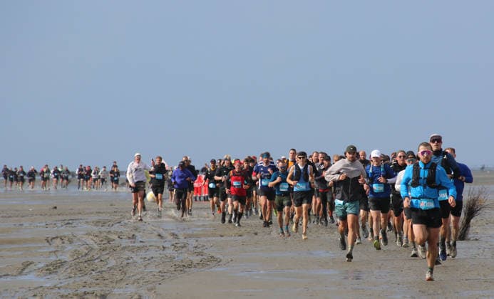 Participants in the 2nd Red Bull Watt Run from the beach in Duhnen to Neuwerk and back. Because a strong westerly wind had pushed a lot of water into the southwestern part of the German Bight in the days leading up to the event, the route had to be adjusted.