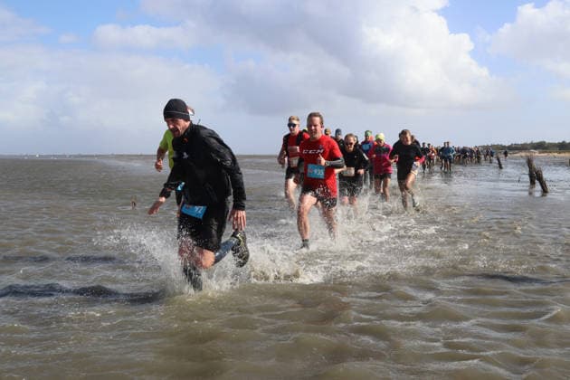 Participants in the 2nd Red Bull Watt Run from the beach in Duhnen to Neuwerk and back. Because a strong westerly wind had pushed a lot of water into the southwestern part of the German Bight in the days leading up to the event, the route had to be adjusted.