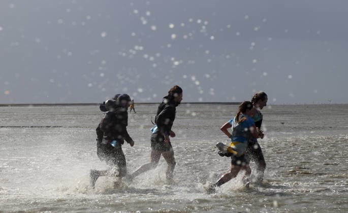 Participants in the 2nd Red Bull Watt Run from the beach in Duhnen to Neuwerk and back. Because a strong westerly wind had pushed a lot of water into the southwestern part of the German Bight in the days leading up to the event, the route had to be adjusted.