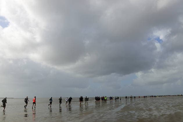 Participants in the 2nd Red Bull Watt Run from the beach in Duhnen to Neuwerk and back. Because a strong westerly wind had pushed a lot of water into the southwestern part of the German Bight in the days leading up to the event, the route had to be adjusted.