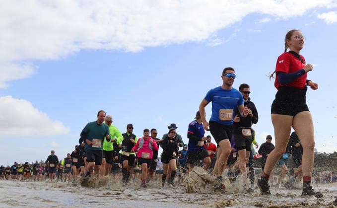 Participants in the 2nd Red Bull Watt Run from the beach in Duhnen to Neuwerk and back. Because a strong westerly wind had pushed a lot of water into the southwestern part of the German Bight in the days leading up to the event, the route had to be adjusted
