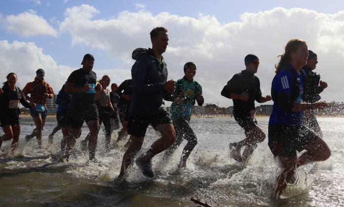Participants in the 2nd Red Bull Watt Run from the beach in Duhnen to Neuwerk and back. Because a strong westerly wind had pushed a lot of water into the southwestern part of the German Bight in the days leading up to the event, the route had to be adjusted.