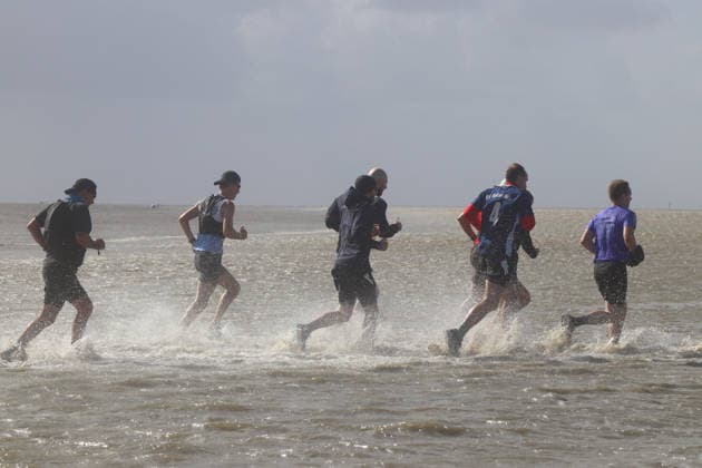 Participants in the 2nd Red Bull Watt Run from the beach in Duhnen to Neuwerk and back. Because a strong westerly wind had pushed a lot of water into the southwestern part of the German Bight in the days leading up to the event, the route had to be adjusted.