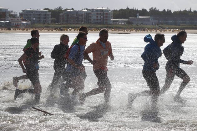Participants in the 2nd Red Bull Watt Run from the beach in Duhnen to Neuwerk and back. Because a strong westerly wind had pushed a lot of water into the southwestern part of the German Bight in the days leading up to the event, the route had to be adjusted.