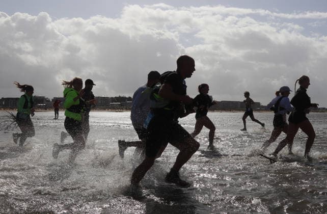 Participants in the 2nd Red Bull Watt Run from the beach in Duhnen to Neuwerk and back. Because a strong westerly wind had pushed a lot of water into the southwestern part of the German Bight in the days leading up to the event, the route had to be adjusted.
