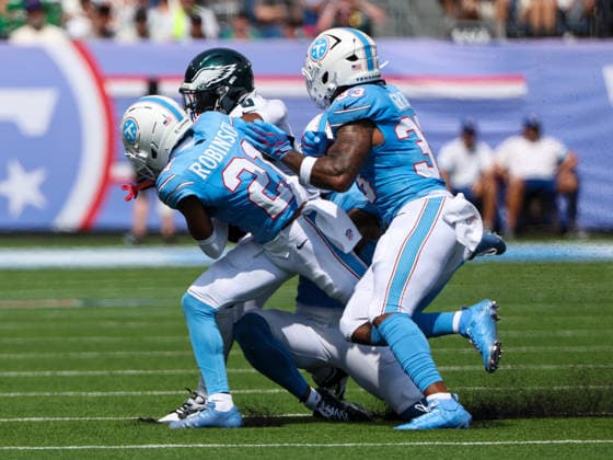 Sep 20, 2026; Nashville, TN, USA; Philadelphia Eagles running back Tank Bigsby (8) is tackled by Tennessee Titans cornerback Micah Robinson (21) and linebacker Cedric Gray (33) during the NFL, American Football Herren, USA regular season game between the Philadelphia Eagles and Tennessee Titans at Nissan Stadium. Mandatory Credit: -Cal Media NFL 2026: Eagles Vs Titans SEP 20  - ZUMAc04_ 20260920_zma_c04_024 Copyright: xStephenxFurstx