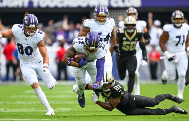 Baltimore Ravens running back Derrick Henry (22) charges over New Orleans Saints safety Justin Reid (21) for a first down during the first quarter of the Ravens home opener game at M&T Bank Stadium in Baltimore, Maryland, on Sunday, September 20, 2026.  BAL20260920103 DAVIDxTULIS