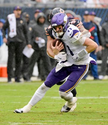 Minnesota Vikings quarterback Carson Wentz (11) is sacked by Chicago Bears running back Roschon Johnson (23) late in the second quarter during a game at Soldier Field in Chicago on Sunday, September 20, 2026.  CHI20260920111 MARKxBLACK