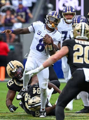Baltimore Ravens quarterback Lamar Jackson (8) runs into the New Orleans Saints defensive unit during the fourth quarter at M&T Bank Stadium in Baltimore, Maryland, on Sunday, September 20, 2026. The New Orleans Saints won 24-17.  BAL20260920142 DAVIDxTULIS