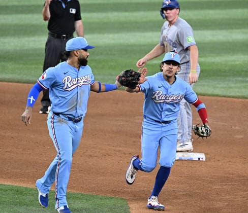 Texas Rangers shortstop Ezequiel Duran, left, and second baseman Nicky Lopez celebrate turning a double play to end the fifth inning against the the Toronto Blue Jays at Globe Life Field on Sunday, September 20, 2026, in Arlington, TX. The Blue Jays defeated the Rangers 7-2.  ARL2026092011 IANxHALPERIN