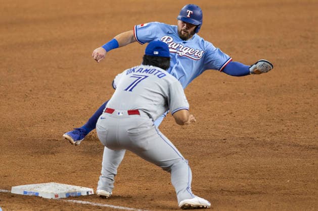 September 20, 2026, Arlington, Texas, USA: Texas Rangers first baseman JAKE BURGER (21) slides into third base against the Toronto Blue Jays at Globe Life Field. Blue Jays win 7-2. MLB, Baseball Herren, USA 2026: Blue Jays 7;2 Rangers  - ZUMAf180 20260920_zsp_f180_013 Copyright: xMarkxFannx