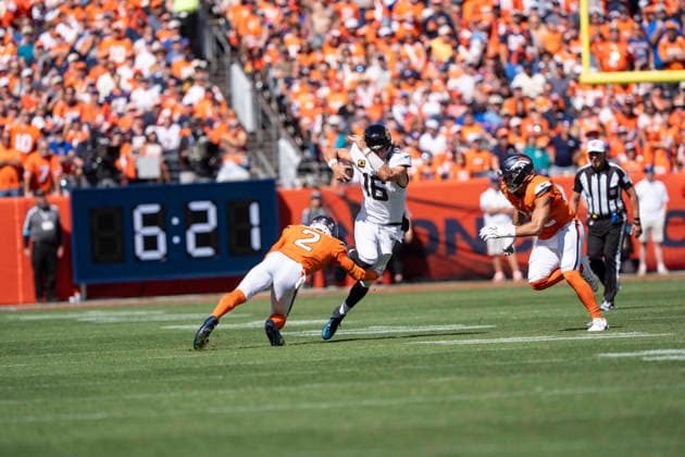 Sep 20, 2026; Jacksonville Jaguars quarterback Trevor Lawrence (16) tries to avoid Denver Broncos cornerback Pat Surtain II (2) during the game between the Denver Broncos and Jacksonville Jaguars in Denver, CO, USA; at Empower Field at Mile High. Mandatory Credit: -Cal Media - ZUMAc04_ 20260920_zma_c04_309 Copyright: xDerekxRegensburgerx