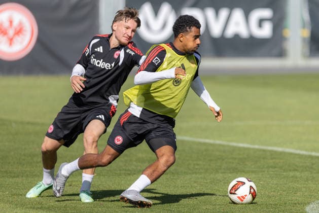 Eintracht Frankfurt Training: Ansgar Knauff (No. 7) of Eintracht Frankfurt is tackled by Niko Ilicevic of Eintracht Frankfurt U21 during a training session on September 22, 2026, at Deutsche Bank Park in Frankfurt am Main, Frankfurt am Main, Hesse, Germany; Deutsche Bank Park