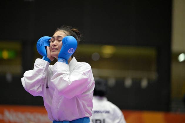 (260922) -- TOYOHASHI, Sept. 22, 2026 -- Adeola Fay Robert of Malaysia celebrates against Fatemehzahra Saeidabadi of Iran after the women s kumite -55kg final of Karate at the 20th Asian Games Aichi-Nagoya 2026 in Toyohashi, Japan, Sept. 22, 2026. ) (SP)JAPAN-TOYOHASHI-ASIAN GAMES-KARATE-WOMEN S-55KG FINAL YuxYang 