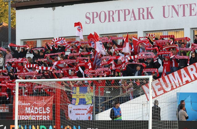 Soccer, Women s Champions League, 2026–2027 season, FC Bayern Munich vs. Manchester City, Matchday 1, Sportpark Unterhaching: FC Bayern fans with flags, scarves, cheering, and choreographed displays