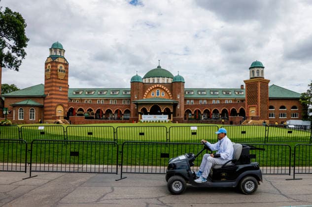 A golf cart passes in front of the clubhouse during practice for the Presidents Cup golf tournament at Medinah Country Club in Medinah, Illinois on Tuesday, September 22, 2026. Competition between the USA and the International team begins on Thursday, September 24 with Four-Ball play.  MED20260922906 TANNENxMAURY