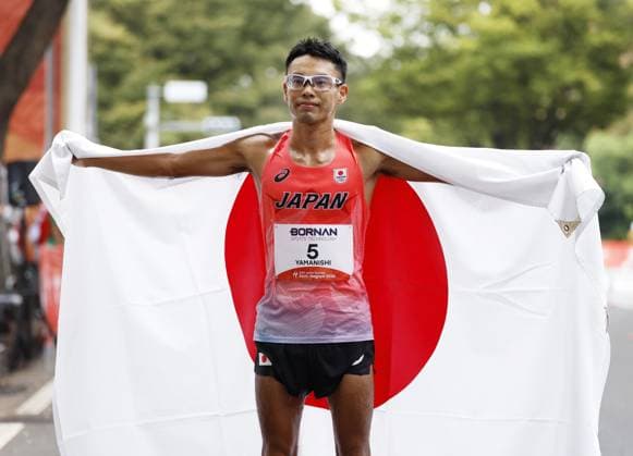Aichi-Nagoya Asian Games: Athletics Japan s Toshikazu Yamanishi poses after winning the Aichi-Nagoya Asian Games men s half marathon race walk silver in Nagoya, central Japan, on Sept. 23, 2026.  A14AA0005628320P