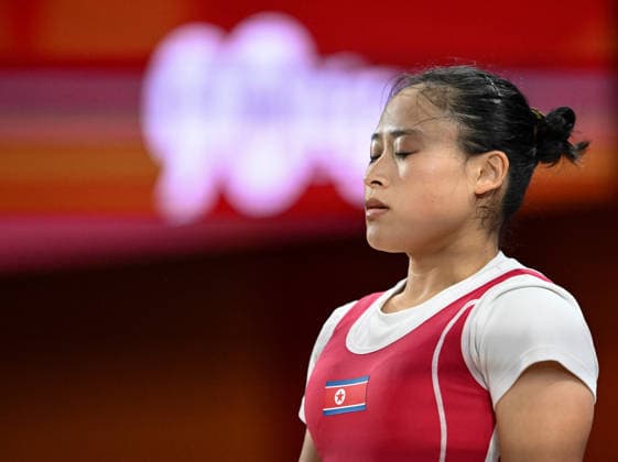 (260923) -- NAGOYA, Sept. 23, 2026 -- Ri Song Gum of the Democratic People s Republic of Korea reacts during the women s 49kg final of weightlifting at the 20th Asian Games Aichi-Nagoya 2026 in Nagoya, Japan, Sept. 23, 2026. ) (SP)JAPAN-NAGOYA-ASIAN GAMES-WEIGHTLIFTING-WOMEN S 49KG YuxYang 