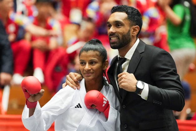 (260923) -- TOYOHASHI, Sept. 23, 2026 -- Shahmalarani Chandran (L) of Malaysia celebrates with her coach after defeating Tsang Yee Ting of China s Hong Kong in the women s kumite -50kg final of Karate at the 20th Asian Games Aichi-Nagoya 2026 in Toyohashi of Aichi Prefecture, Japan, Sept. 23, 2026. ) (SP)JAPAN-TOYOHASHI-ASIAN GAMES-KARATE-WOMEN S KUMITE-50KG FINAL WangxFei 