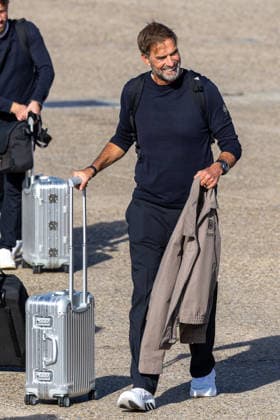 Departure of the German DFB national soccer team for Amsterdam for the Nations League match against the Netherlands, Nuremberg, September 23, 2026. National team coach Jürgen Klopp walks across the tarmac smiling, carrying a rolling suitcase and wearing a jacket. The team is traveling to Amsterdam for the match against the Netherlands. Nuremberg, Bavaria, Germany 20260923-1V9A8821-M4000