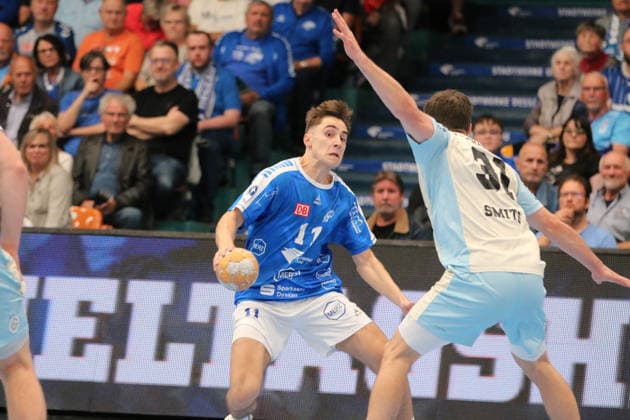 September 23, 2026 Men s Handball 2026–2027 DHB Cup, Round 2: Dessau Roßlauer HV 06 vs. VfL Gummersbach, Anhalt Arena, Dessau. Alen Hadzimuhamedovic (Dessau, 11, in blue has the ball; Kay Smits, Gummersbach, 31, in white, blocks his path; Dessau Roßlau, Saxony-Anhalt, Germany