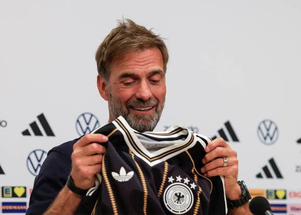 Jurgen Klopp manager of Germany holds up a Germany national team, Nationalteam shirt as he speaks at a German team press conference, PK, Pressekonferenz at the Johan Cruyff Arena, Amsterdam. Picture date: 23rd September 2026. Picture credit should read: Cody Froggatt Sportimage EDITORIAL USE ONLY. No use with unauthorised audio, video, data, fixture lists, club league logos or live services. Online in-match use limited to 120 images, no video emulation. No use in betting, games or single club league player publications. SPI_016_CF_GERMANY_PRESS SPI-5044-0014