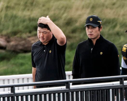 International team member Sungjae Im of South Korea (L) and International team member Hideki Matsuyama of Japan walk across a bridge to the fourteenth fairway during practice for the Presidents Cup golf tournament at Medinah Country Club in Medinah, Illinois on Wednesday, September 23, 2026. Competition between the USA and the International team begins on Thursday, September 24 with Four-Ball play.  MED20260923820 TANNENxMAURY