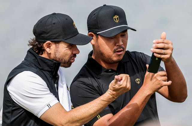 International team member Si Woo Kim of South Korea confers with his caddie on the sixteenth green during practice for the Presidents Cup golf tournament at Medinah Country Club in Medinah, Illinois on Wednesday, September 23, 2026. Competition between the USA and the International team begins on Thursday, September 24 with Four-Ball play.  MED20260923817 TANNENxMAURY
