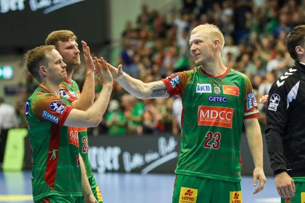 September 23, 2026, xgox, Handball DHB Cup, Round 2: SC Magdeburg vs. HSG Wetzlar emspor, from left: Omar Ingi Magnusson (Magdeburg), 14, Magnus Saugstrup (Magdeburg), 23; celebrating the victory, Celebrations after the game in Magdeburg