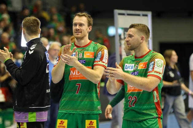 September 23, 2026, xgox, Handball DHB Cup, Round 2: SC Magdeburg vs. HSG Wetzlar, emspor; from left: Felix Claar (Magdeburg), 7; Lukas Mertens (Magdeburg), 22; celebrating the victory, Celebrations after the game in Magdeburg