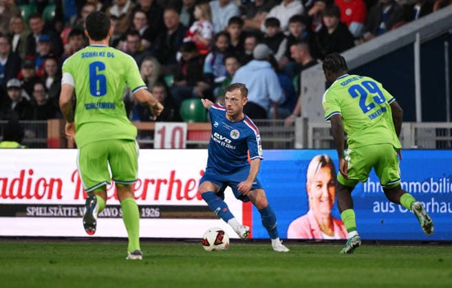 Max Meyer of Rot Weiss Oberhausen (left) against Junior Dina Ebimbe of FC Schalke 04 (right) and Ron Schallenberg of FC Schalke 04 on September 24, 2026, 2026–2027 soccer season, friendly match, Rot-Weiss Oberhausen vs. FC Schalke 04, Oberhausen, Niederrheinstadion, North Rhine-Westphalia, Germany Team2