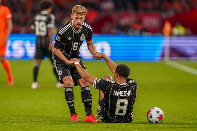 2026-09-24 Netherlands v Germany - Nations League AMSTERDAM, NETHERLANDS - SEPTEMBER 24: Joshua Kimmich of Germany helps Felix Nmecha of Germany during the Nations League match between Netherlands and Germany at Johan Cruijff ArenA Amsterdam Johan Cruijff ArenA Netherlands Content not available for redistribution in The Netherlands directly or indirectly through any third parties. Copyright: xAndrexWeeningx
