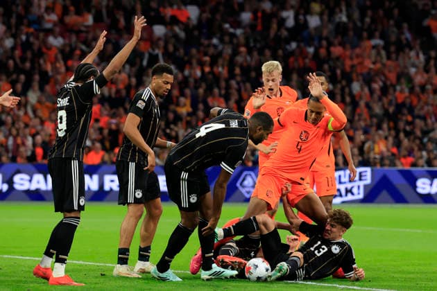 Amsterdam, Netherlands, 24th September 2026. Jonathan Tah (C) and Philipp Treu (R) of Germany challenge with Virgil van Dijk (2nd R) of the Netherlands to clear the ball during the Netherlands vs Germany UEFA Nations League match at the Johan Cruyff Arena, Amsterdam. Picture credit should read: Cody Froggatt Sportimage EDITORIAL USE ONLY. No use with unauthorised audio, video, data, fixture lists, club league logos or live services. Online in-match use limited to 120 images, no video emulation. No use in betting, games or single club league player publications. SPI_082_CF_NETHERLANDS_V_GERMANY SPI-5017-0082