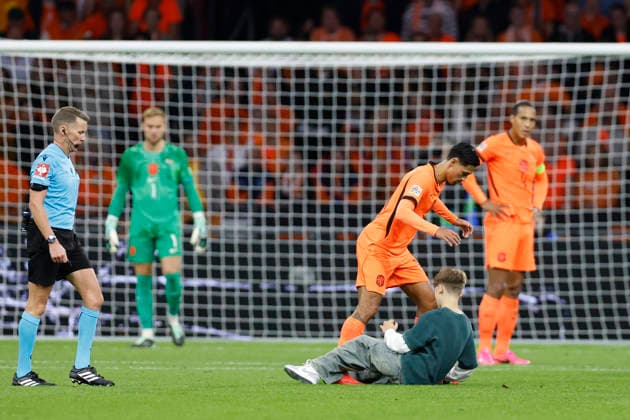 Amsterdam, Netherlands, 24th September 2026. A pitch invaded tangles with Tijjani Reijnders of the Netherlands during the Netherlands vs Germany UEFA Nations League match at the Johan Cruyff Arena, Amsterdam. Picture credit should read: Cody Froggatt Sportimage EDITORIAL USE ONLY. No use with unauthorised audio, video, data, fixture lists, club league logos or live services. Online in-match use limited to 120 images, no video emulation. No use in betting, games or single club league player publications. SPI_089_CF_NETHERLANDS_V_GERMANY SPI-5017-0089