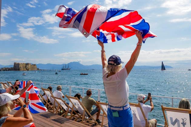 THE LOUIS VUITTON 38TH AMERICA™S CUP PRELIMINARY REGATTA, NAPLES A fan of Team Great Britain waves as GB1 and GB2 pass competes on the first day of the preliminary regatta for the 38th Louis Vuitton America™s Cup in the Gulf of Naples, Campania, Italy, on September 25, 2026. The Naples preliminary regatta gives the competing teams their first opportunity to test their AC40 one-design yachts ahead of the 38th America™s Cup, which will be held in Naples in 2027. ABP12514 Copyright: xAntonioxBalascox