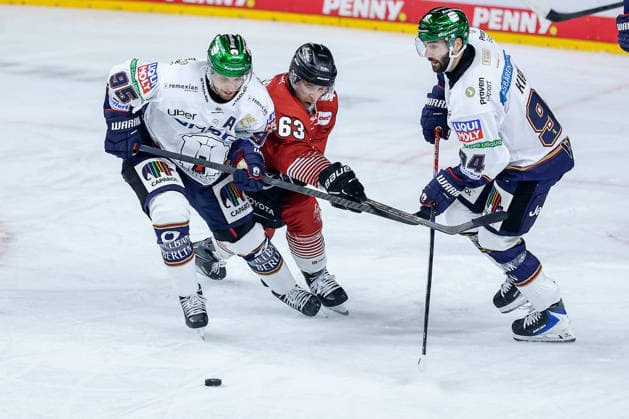 September 25, 2026, Ice Hockey, DEL, Kölner Haie vs. Eisbären Berlin, Matchday 3, 2026–27 Season, Lanxess Arena, Cologne: Frederik Tiffels (Eisbären Berlin, 95) and Liam Kirk (Eisbären Berlin, 94) in a one-on-one battle against Patrick Russell (Kölner Haie, 63), North Rhine-Westphalia, Germany