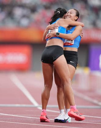 (260926) -- NAGOYA, Sept. 26, 2026 -- Lo Ying Chiu (L) of Hong Kong, China hugs her teammate Wong Cheuk Ning after the women s marathon final of athletics at the 20th Asian Games Aichi-Nagoya 2026 in Nagoya, Japan, Sept. 26, 2026. Lui Siu Wai) (SP)JAPAN-NAGOYA-ASIAN GAMES-ATHLETICS-WOMEN S MARATHON LvxXiaowei 