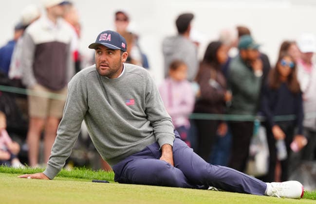 MEDINAH, IL - SEPTEMBER 25: Team USA golfer Scottie Scheffler sits down on the ground looking dejected after losing the match on the 18th hole during the second round of the 2026 Presidents Cup on September 25, 2026, at Medinah Country Club in Medinah, Illinois. (Photo by Brian Spurlock Icon Sportswire) GOLF: SEP 25 Presidents Cup EDITORIAL USE ONLY Icon260925122