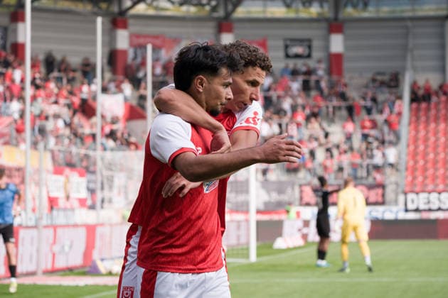 Osman Atilgan (HFC, 10) is embraced by Soufian Benyamina (HFC, 90) after scoring the goal that tied the game at 2–2, Hallescher FC vs. BFC Preussen 1894 e.V., soccer, Regionalliga Nordost, Matchday 11, 2026–27 season, September 26, 2026, Halle Leuna Chemie Stadium, ST, Germany