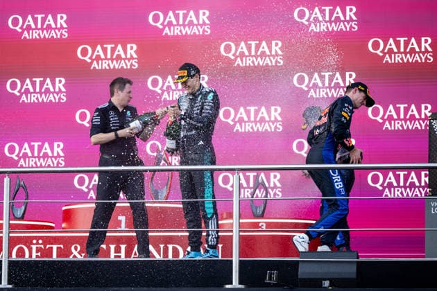 September 26, 2026, AZE, Motorsports, FIA Formula 1 World Championship, 2026 Season, Baku City Circuit, Azerbaijan Grand Prix: George Russell of the Mercedes AMG Petronas F1 Team, Great Britain, No. 63, celebrates his victory on the podium with Chris Nelson during the awards ceremony and sprays champagne; next to him is Max Verstappen of Oracle Red Bull Racing, Netherlands, 03 Baku, Baku City Circuit, Azerbaijan Copyright: xNordphoto Memmlerx