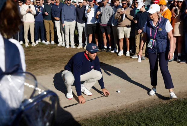 Scottie Scheffler of the United States prepares to hit off the pavement on the fourth fairway in a four-ball match during the third round of the 2026 President s Cup golf tournament at Medinah Country Club in Chicago, Illinois, on Saturday, September 26, 2026.  CHI20260926720 TANNENxMAURY